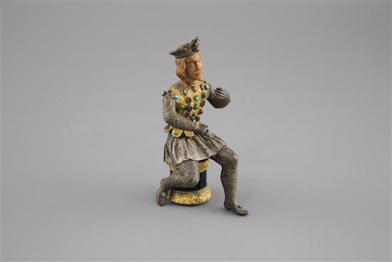 An Austro-Hungarian gilt and white metal figure of a seated knight, with jewelled decoration and hardwood head, height 11.5cm
